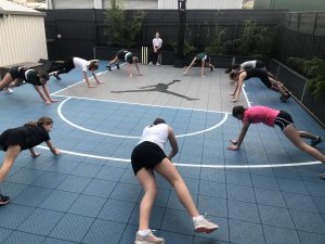 group of kids personal training session on basketball court
