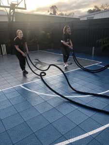 Young women personal training using ropes